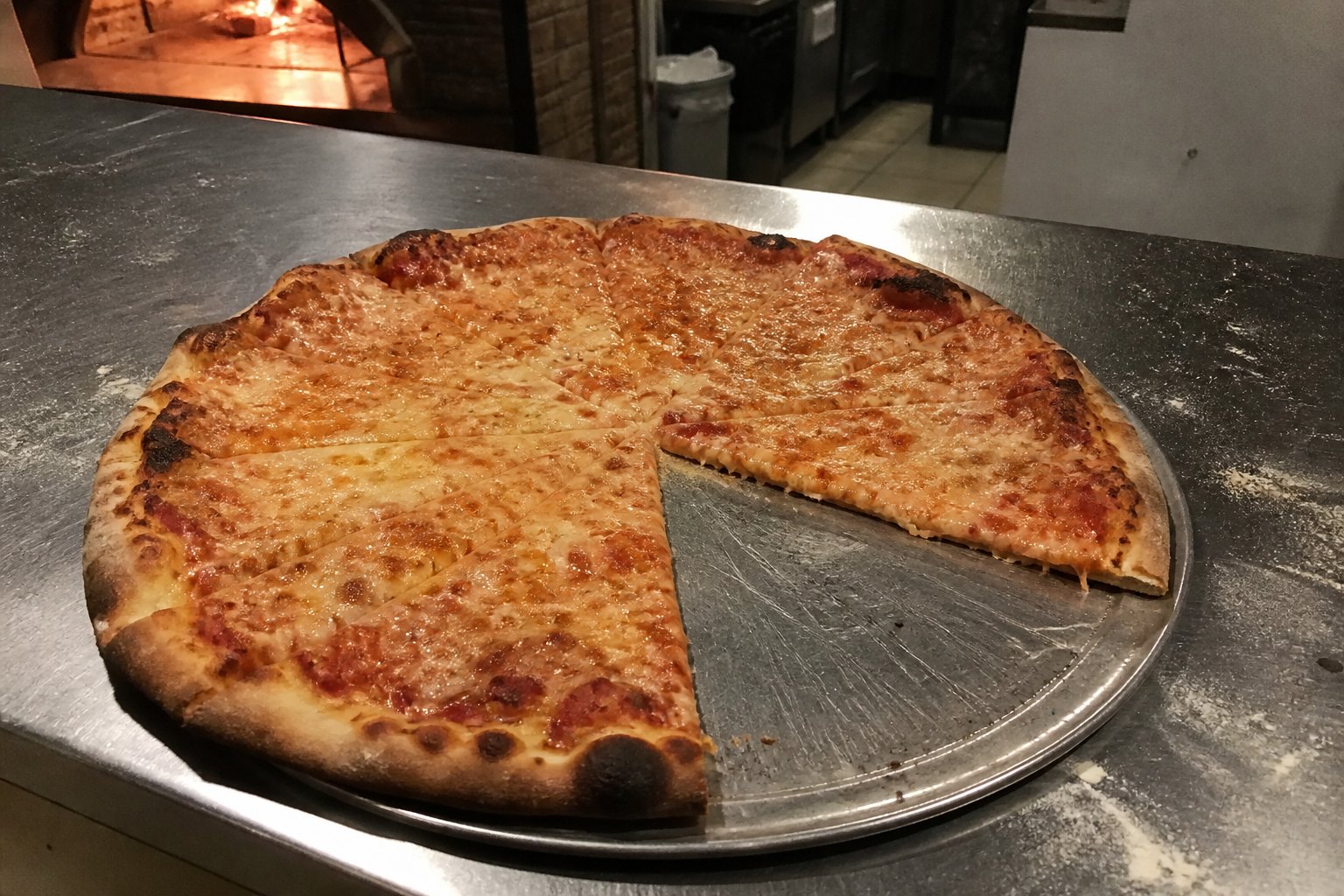 A cheese pizza, still warm from the oven.